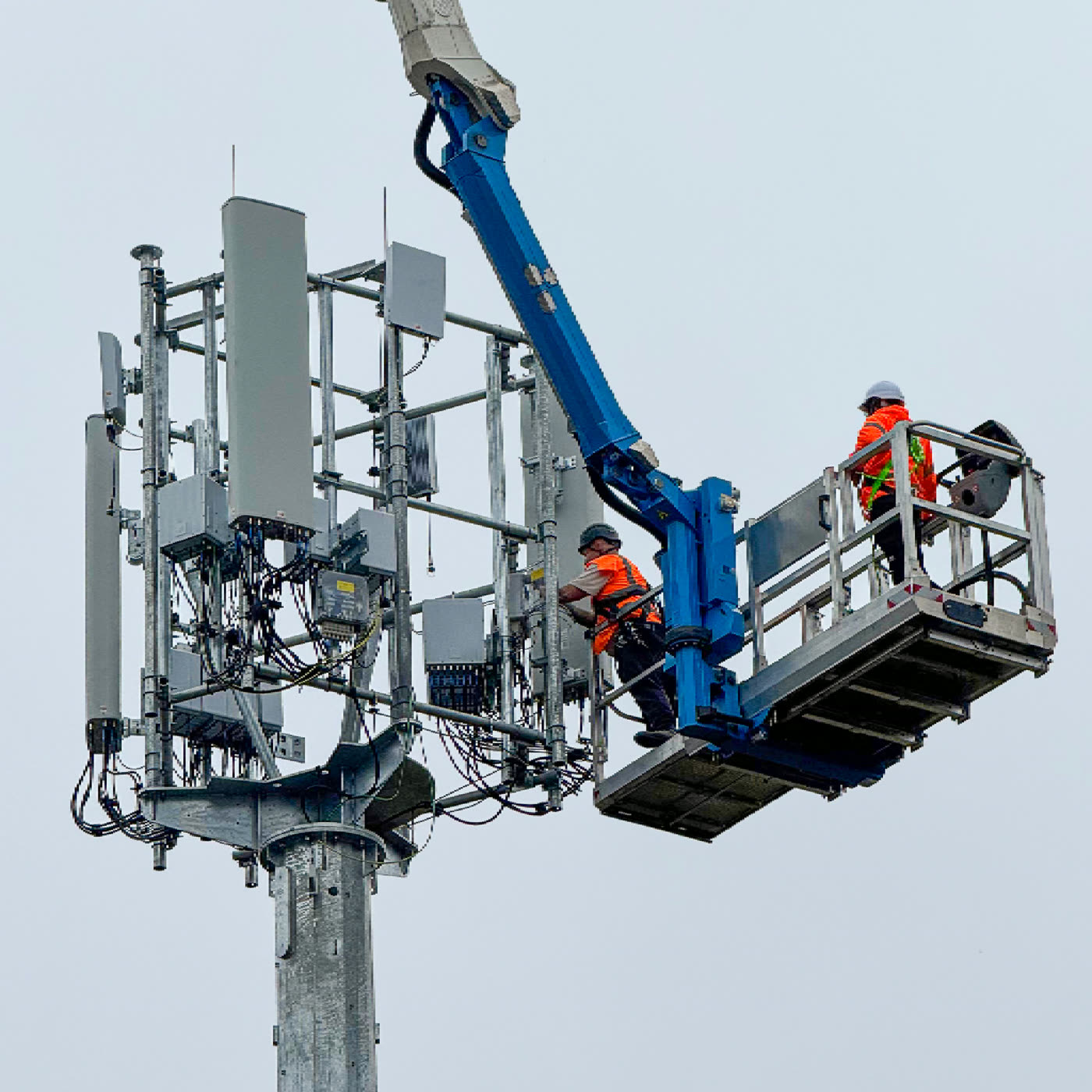 Access platform basket reaching a telecoms mast
