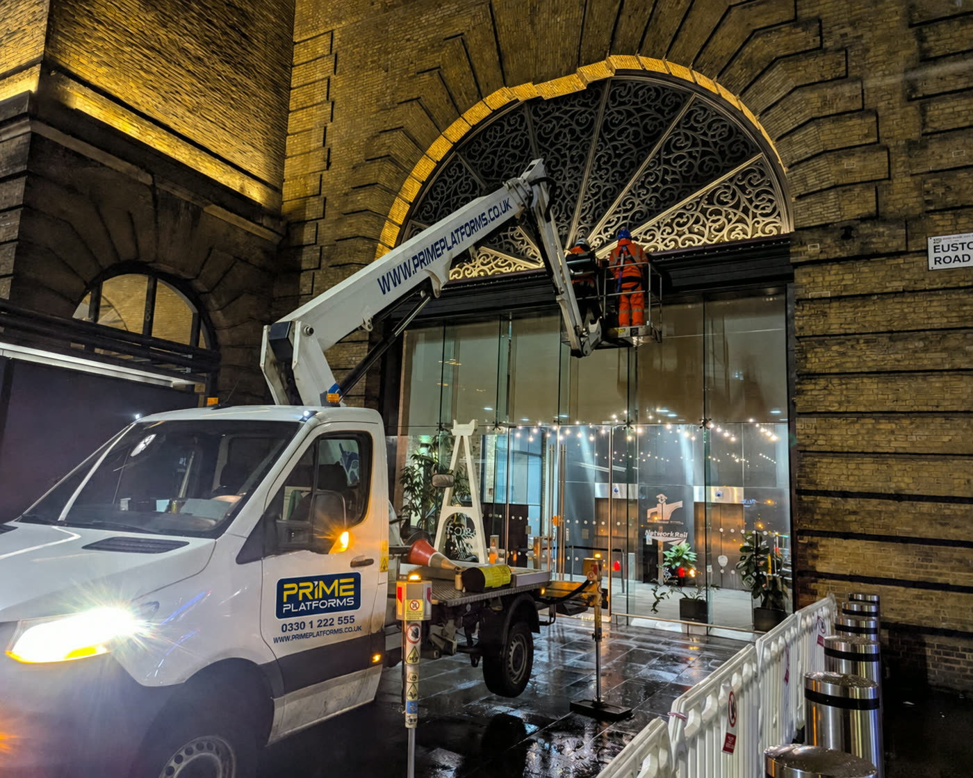 Prime Platforms cherry picker giving access to ornate building archway ironwork at night